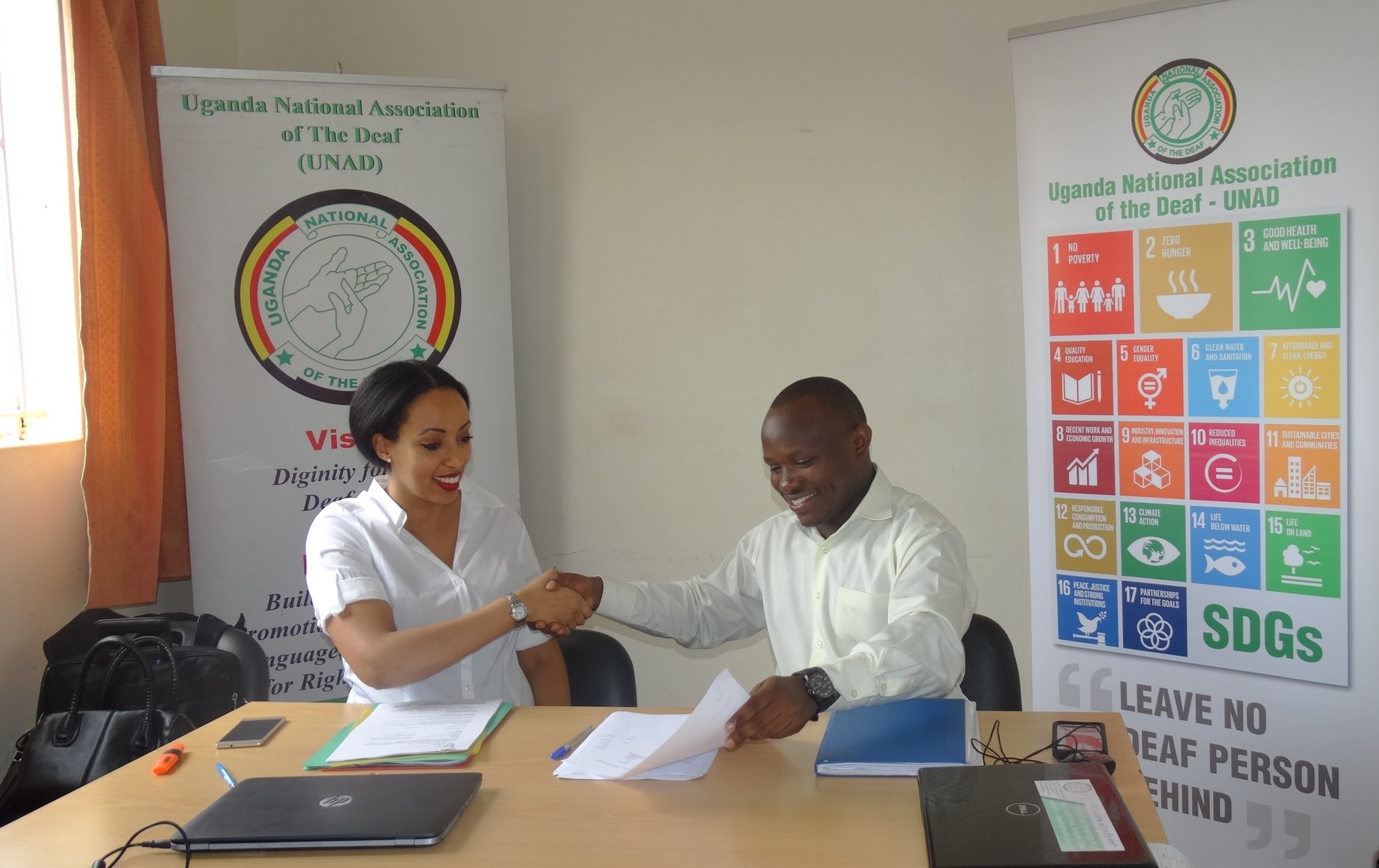 Spider programme manager, Magda Berhe Johnson and UNAD's Ambrose Murangira signing the project agreement
