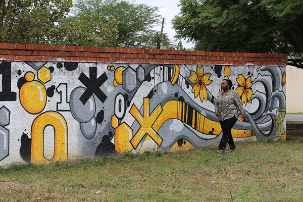 Caroline Wamala Larsson in front of a muralled wall at bongo hive in Zambia